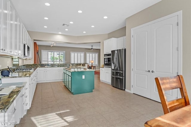 2132 Twin Falls Dr, Henderson, NV 89044 - kitchen featuring stainless steel appliances, recessed lighting, white cabinetry, a peninsula, and stone countertops