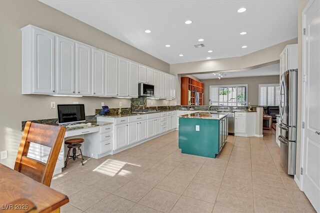 2132 Twin Falls Dr, Henderson, NV 89044 - kitchen with a peninsula, appliances with stainless steel finishes, recessed lighting, and white cabinets