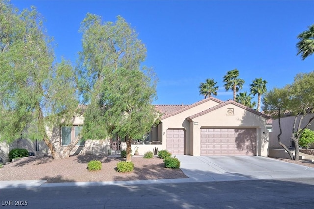 2132 Twin Falls Dr, Henderson, NV 89044 - view of front of property featuring an attached garage, stucco siding, driveway, and a tile roof