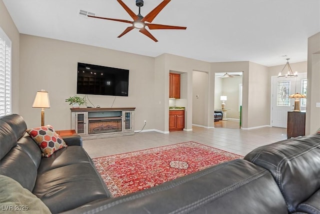 2132 Twin Falls Dr, Henderson, NV 89044 - living area featuring ceiling fan, baseboards, a high end fireplace, a chandelier, and light tile patterned flooring