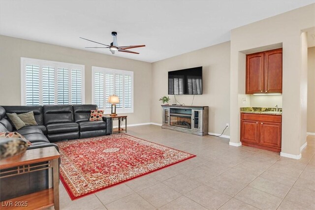 2132 Twin Falls Dr, Henderson, NV 89044 - living room featuring ceiling fan, baseboards, light tile patterned floors, and a fireplace