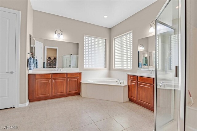 2132 Twin Falls Dr, Henderson, NV 89044 - bathroom with two vanities, a shower stall, a garden tub, tile patterned flooring, and a closet