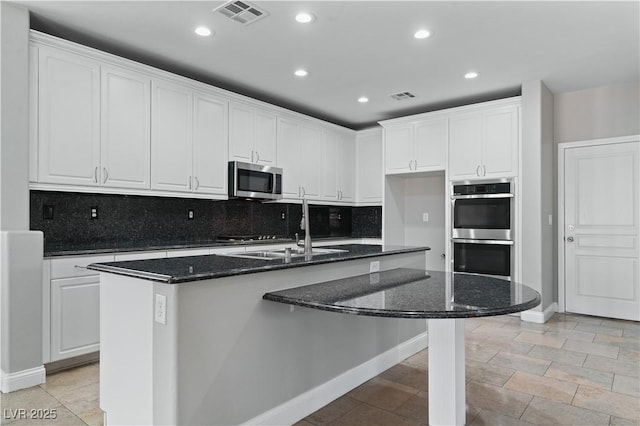 kitchen featuring white cabinets, visible vents, appliances with stainless steel finishes, and recessed lighting