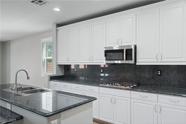kitchen with white cabinetry, visible vents, appliances with stainless steel finishes, and a sink