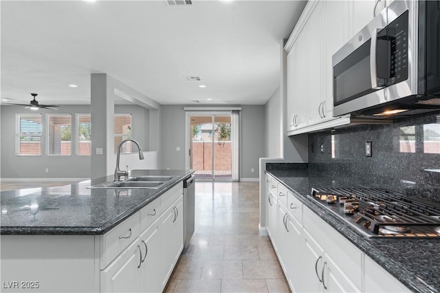 kitchen with recessed lighting, a sink, stainless steel appliances, backsplash, and white cabinets