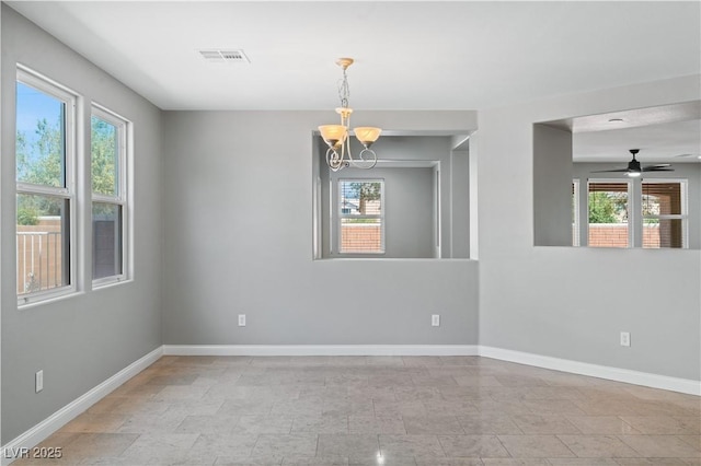 spare room featuring baseboards, visible vents, and ceiling fan with notable chandelier