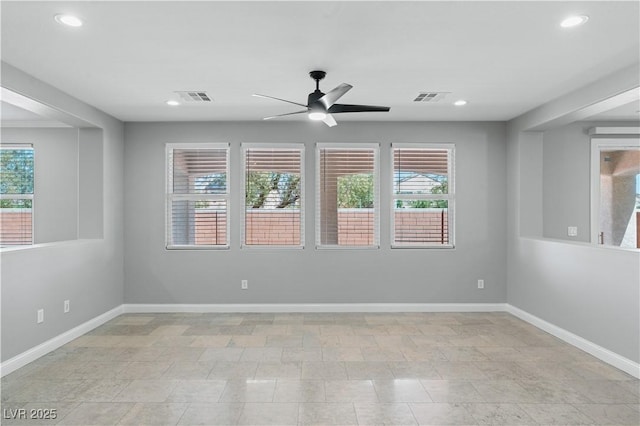 unfurnished room with visible vents, a ceiling fan, and plenty of natural light