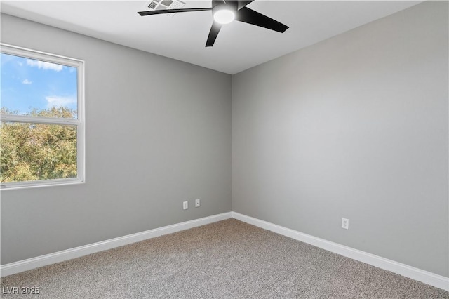 spare room featuring baseboards, ceiling fan, and carpet