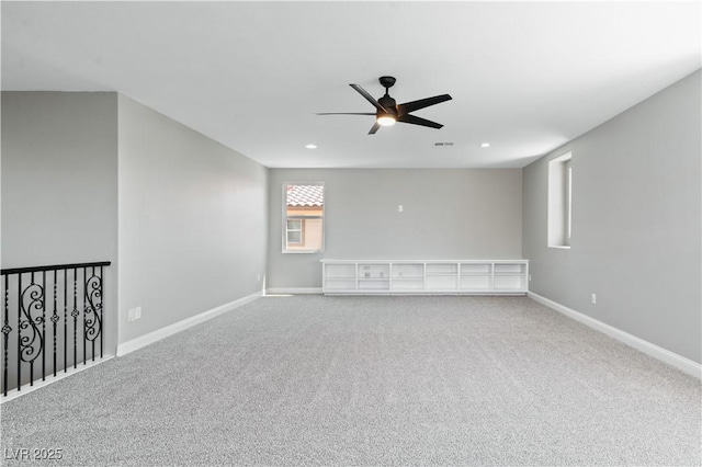 carpeted spare room featuring a ceiling fan, recessed lighting, and baseboards