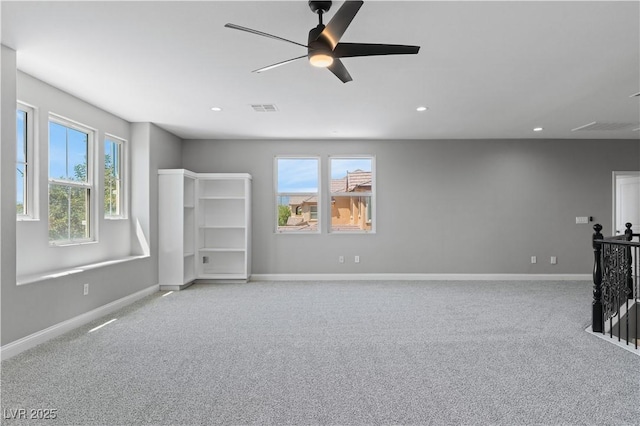 unfurnished living room with visible vents, light carpet, and a healthy amount of sunlight