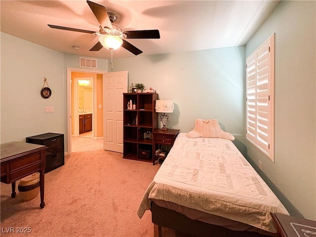 bedroom with visible vents, light carpet, and ceiling fan