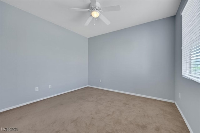 unfurnished room featuring carpet flooring, ceiling fan, and baseboards