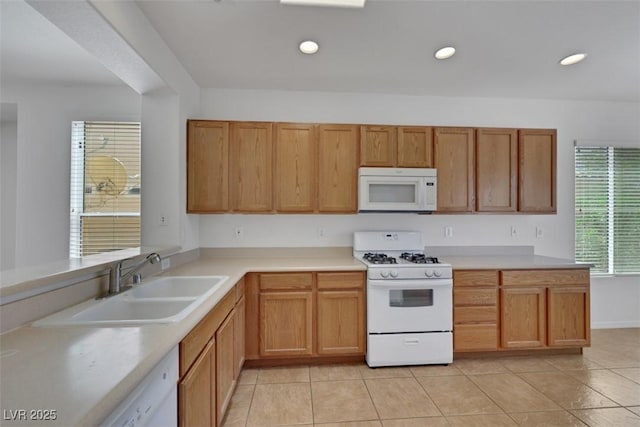 kitchen featuring recessed lighting, white appliances, light tile patterned floors, light countertops, and a sink