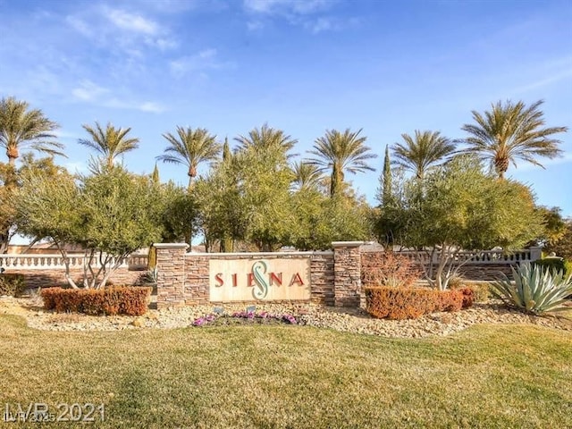 community sign featuring a lawn
