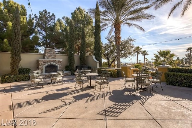 view of patio / terrace featuring an outdoor stone fireplace