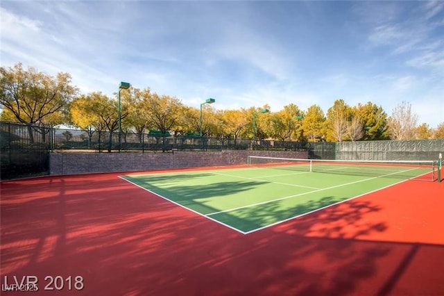 view of tennis court with fence and community basketball court