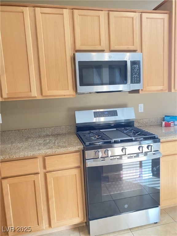 10349 Mystic Pine Rd, Las Vegas, NV 89135 - kitchen featuring light brown cabinets, stainless steel appliances, light countertops, and light tile patterned floors
