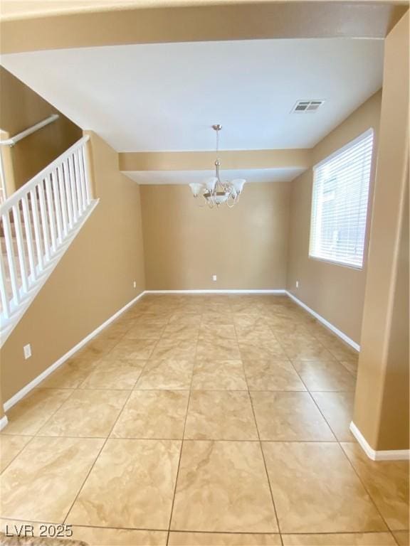 10349 Mystic Pine Rd, Las Vegas, NV 89135 - spare room featuring a chandelier, light tile patterned floors, and baseboards