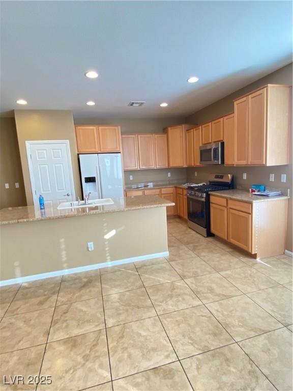 10349 Mystic Pine Rd, Las Vegas, NV 89135 - kitchen featuring appliances with stainless steel finishes, a sink, recessed lighting, light stone countertops, and light brown cabinetry