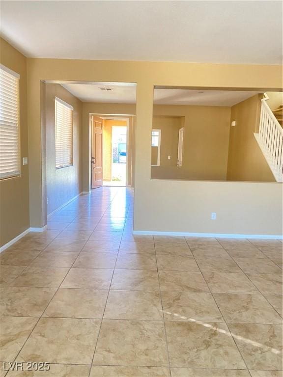 10349 Mystic Pine Rd, Las Vegas, NV 89135 - tiled empty room featuring baseboards and stairs