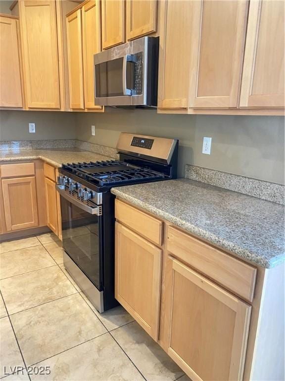 10349 Mystic Pine Rd, Las Vegas, NV 89135 - kitchen featuring appliances with stainless steel finishes, light brown cabinetry, light tile patterned floors, and light countertops