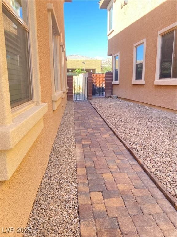 10349 Mystic Pine Rd, Las Vegas, NV 89135 - view of home's exterior with a gate and stucco siding
