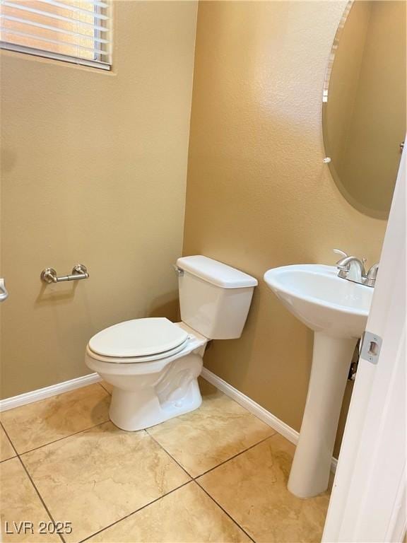 10349 Mystic Pine Rd, Las Vegas, NV 89135 - half bathroom featuring toilet, tile patterned flooring, and baseboards