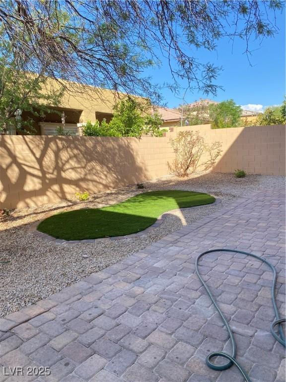 10349 Mystic Pine Rd, Las Vegas, NV 89135 - fenced yard with a patio area