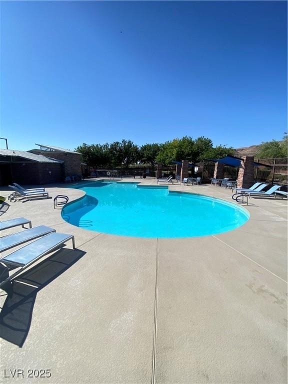10349 Mystic Pine Rd, Las Vegas, NV 89135 - community pool with a patio and fence