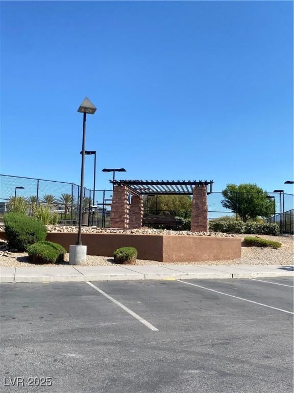 10349 Mystic Pine Rd, Las Vegas, NV 89135 - community sign with fence and uncovered parking