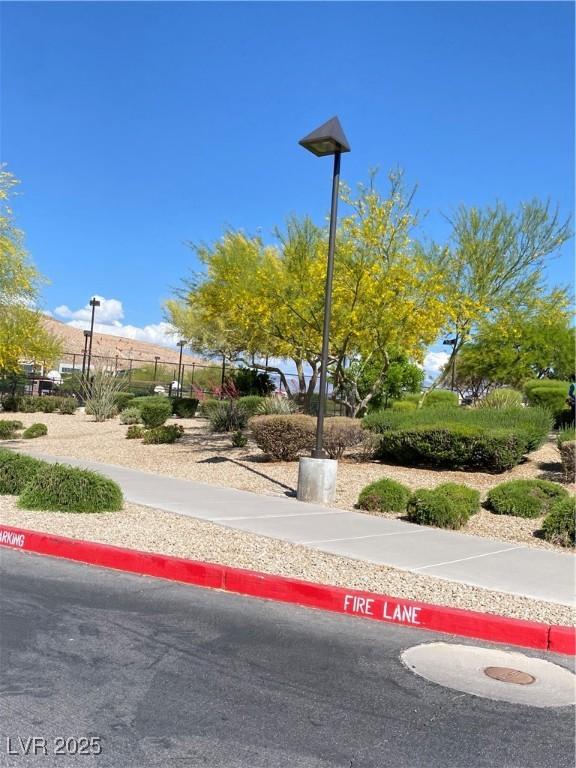 10349 Mystic Pine Rd, Las Vegas, NV 89135 - view of asphalt street featuring street lights, sidewalks, and curbs