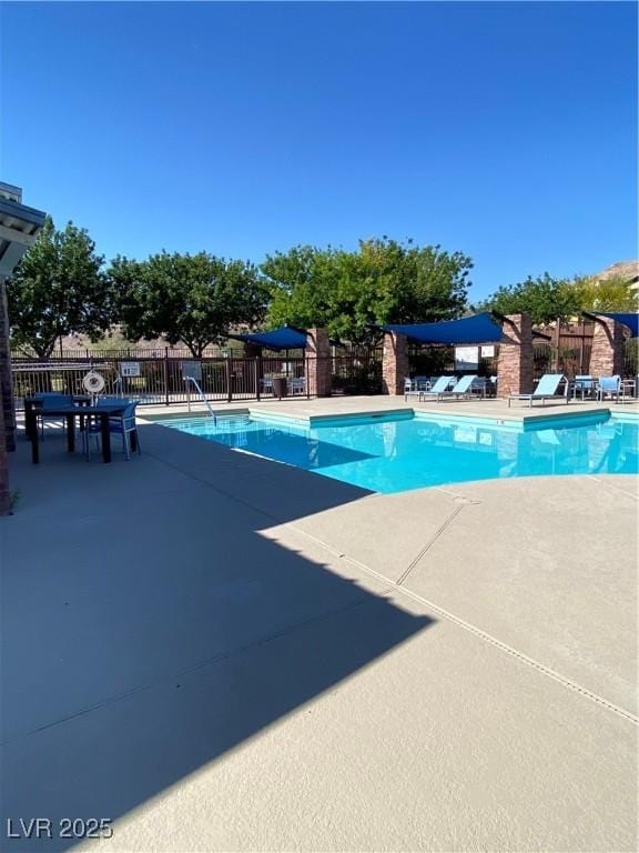10349 Mystic Pine Rd, Las Vegas, NV 89135 - community pool with fence and a patio area