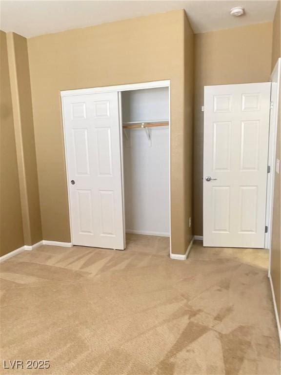 10349 Mystic Pine Rd, Las Vegas, NV 89135 - unfurnished bedroom featuring light colored carpet, a closet, and baseboards