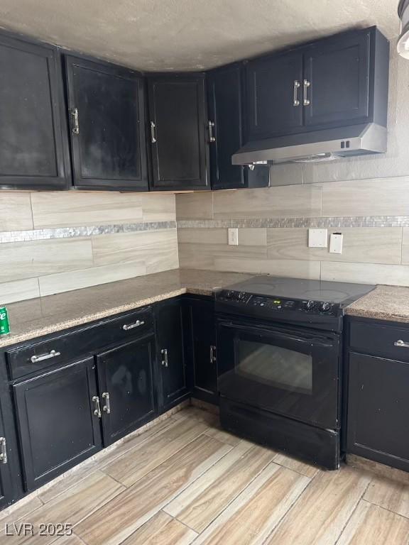 4834 E Van Buren Ave, Las Vegas, NV 89110 - kitchen with electric range, light wood-type flooring, decorative backsplash, and dark cabinetry