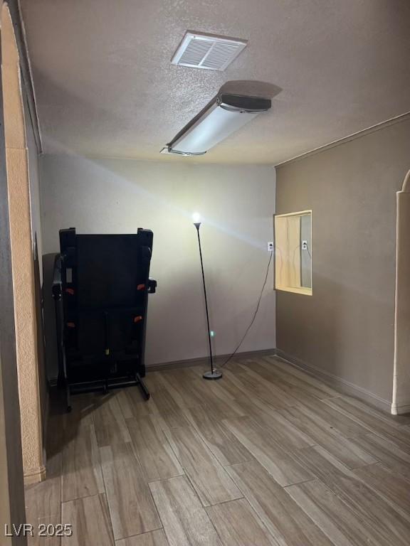 4834 E Van Buren Ave, Las Vegas, NV 89110 - basement featuring wood finished floors, baseboards, and a textured ceiling