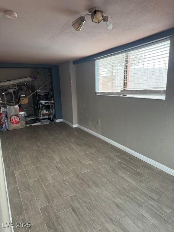 4834 E Van Buren Ave, Las Vegas, NV 89110 - unfurnished living room with a textured ceiling and baseboards