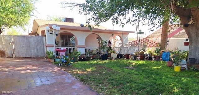 4834 E Van Buren Ave, Las Vegas, NV 89110 - rear view of property with a porch, stucco siding, and a yard