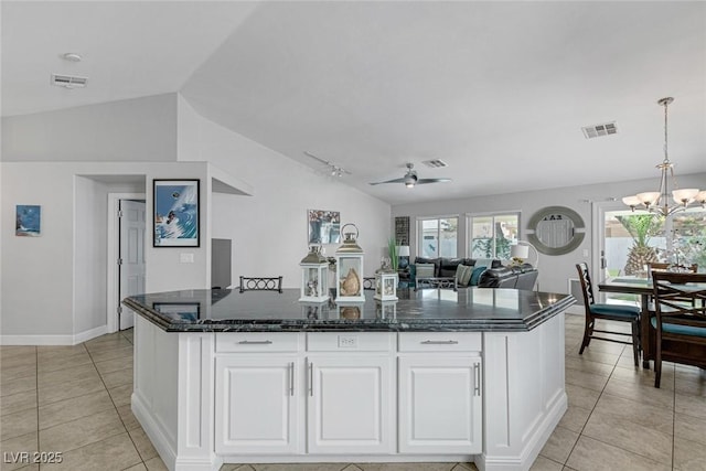 5205 Molveno Ct, Las Vegas, NV 89130 - kitchen featuring lofted ceiling, light tile patterned flooring, a kitchen island, a chandelier, and white cabinets