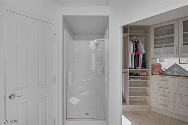 5205 Molveno Ct, Las Vegas, NV 89130 - bathroom featuring a stall shower, tile patterned floors, and a walk in closet