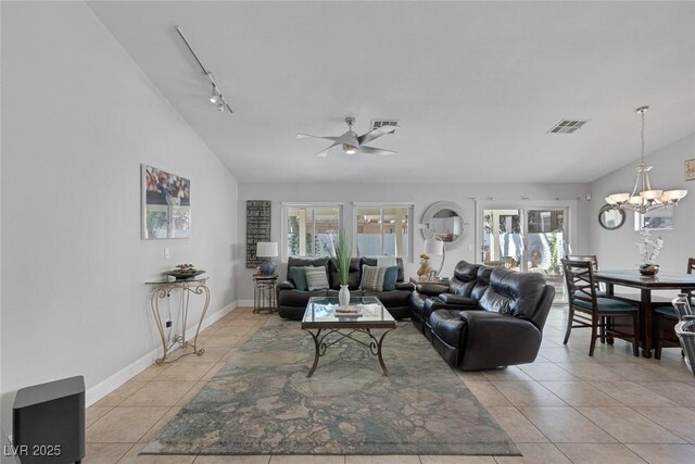 5205 Molveno Ct, Las Vegas, NV 89130 - living area with lofted ceiling, light tile patterned floors, track lighting, ceiling fan, and a chandelier