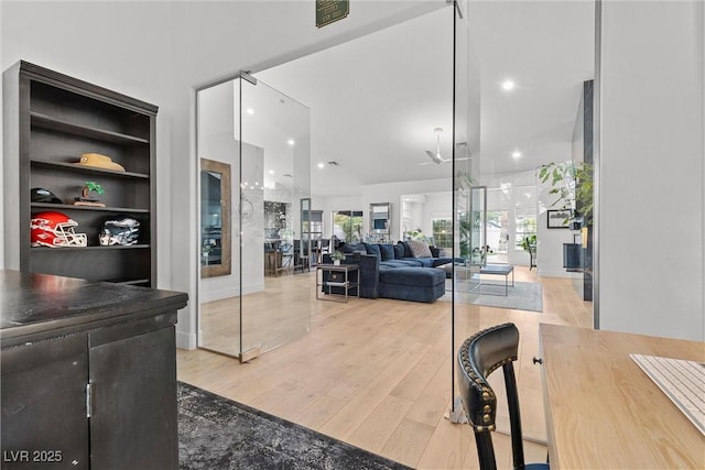 interior space with recessed lighting, built in shelves, and light wood-style floors
