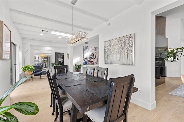 dining space featuring light wood finished floors, recessed lighting, visible vents, and baseboards