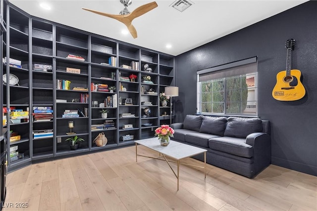 living area with wood finished floors, visible vents, ceiling fan, and recessed lighting