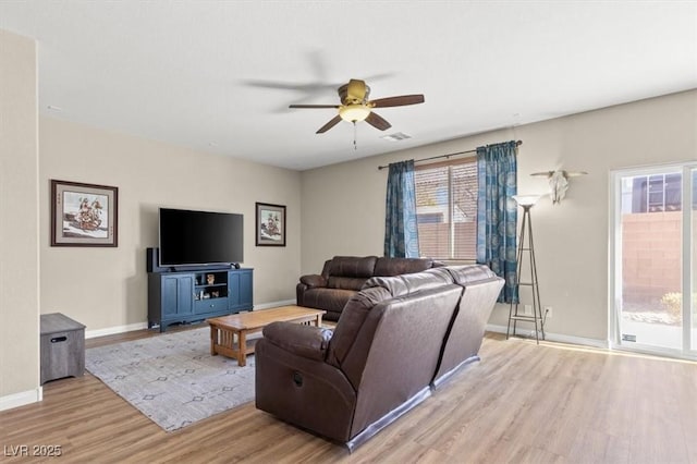 8140 Redbud Vine St, North Las Vegas, NV 89085 - living room with visible vents, ceiling fan, light wood-style flooring, and baseboards