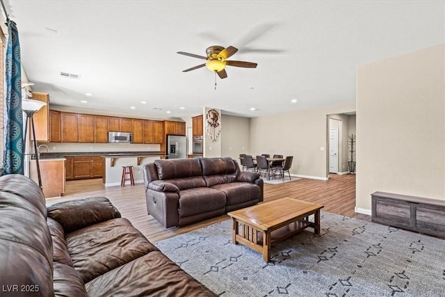 8140 Redbud Vine St, North Las Vegas, NV 89085 - living room with recessed lighting, light wood-type flooring, a ceiling fan, visible vents, and baseboards