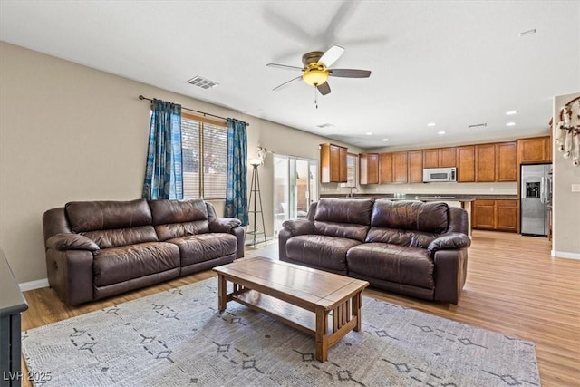 8140 Redbud Vine St, North Las Vegas, NV 89085 - living room featuring baseboards, visible vents, light wood-type flooring, and ceiling fan