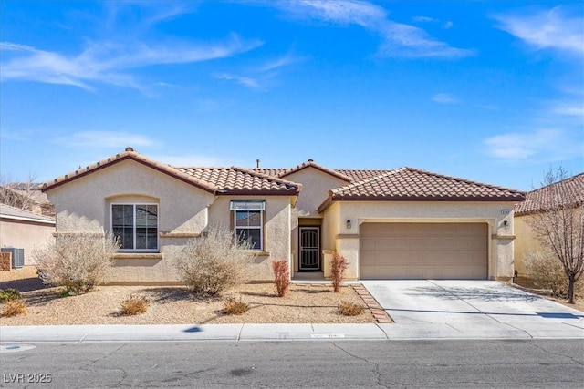 8140 Redbud Vine St, North Las Vegas, NV 89085 - mediterranean / spanish-style house with a tile roof, stucco siding, driveway, and an attached garage