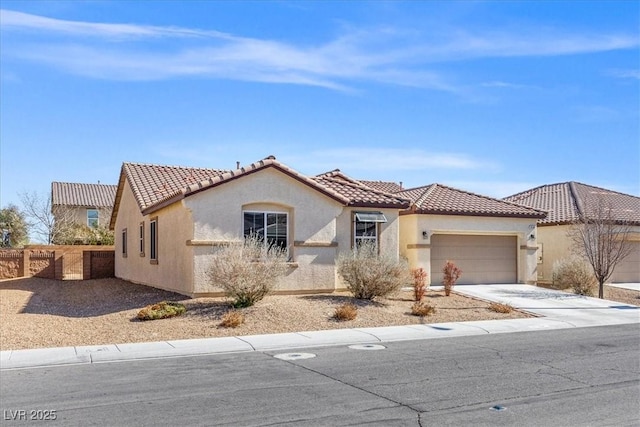 8140 Redbud Vine St, North Las Vegas, NV 89085 - mediterranean / spanish home featuring driveway, fence, a tiled roof, an attached garage, and stucco siding