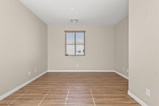 8140 Redbud Vine St, North Las Vegas, NV 89085 - unfurnished room featuring visible vents, wood finished floors, and baseboards