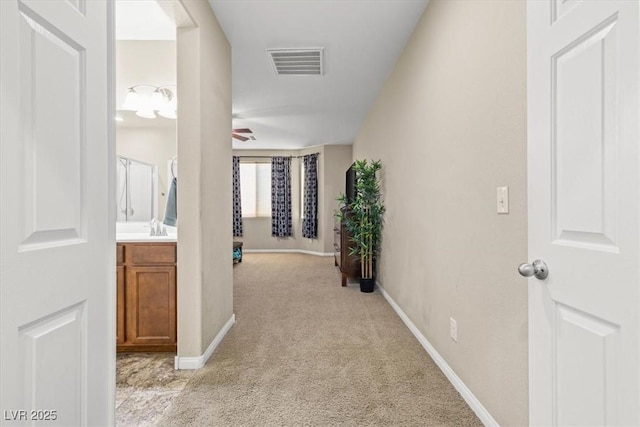 8140 Redbud Vine St, North Las Vegas, NV 89085 - hall featuring baseboards, visible vents, light carpet, and a sink